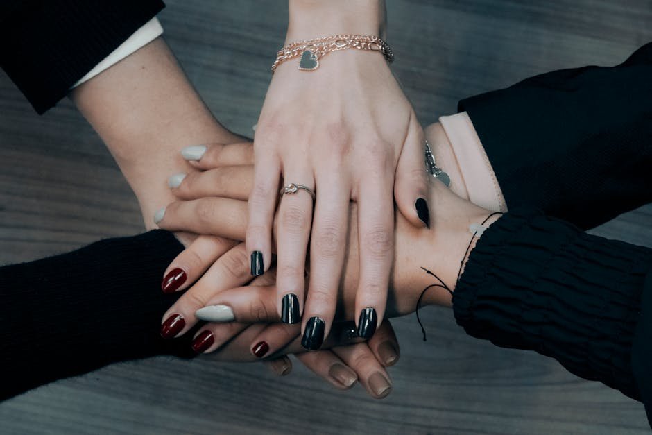 Close-up of diverse hands stacking together symbolizing teamwork, unity, and collaboration.
